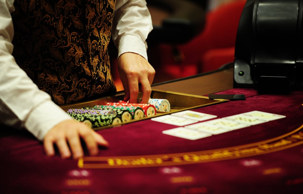 card dealer at casino poker table