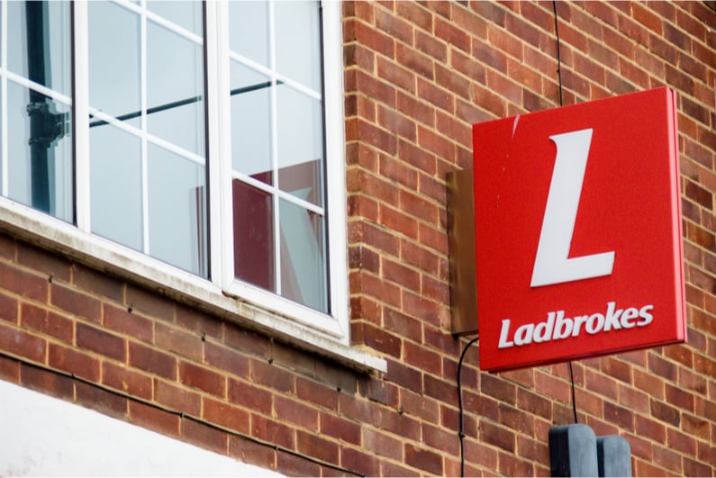 Ladbrokes sign hanging outside a betting shop