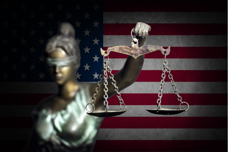 Lady Justice in front of the American flag