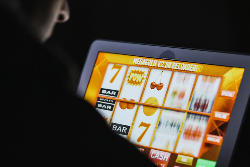 Man playing online slots on a tablet