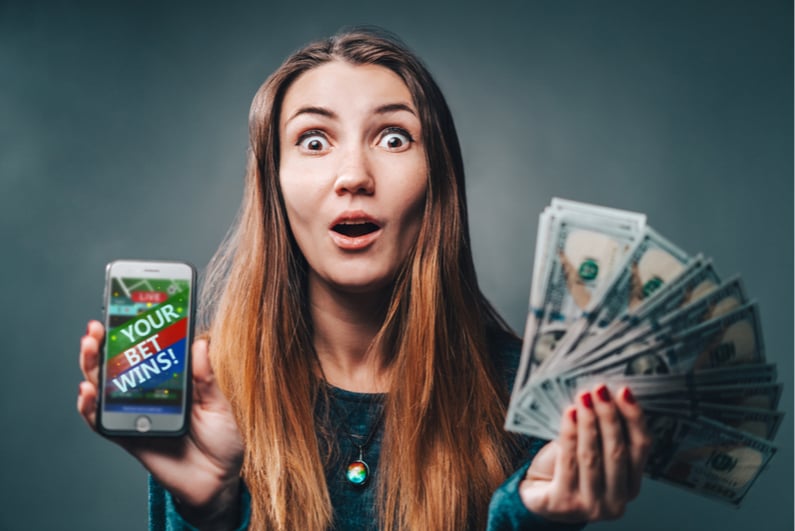 woman holding betting winnings