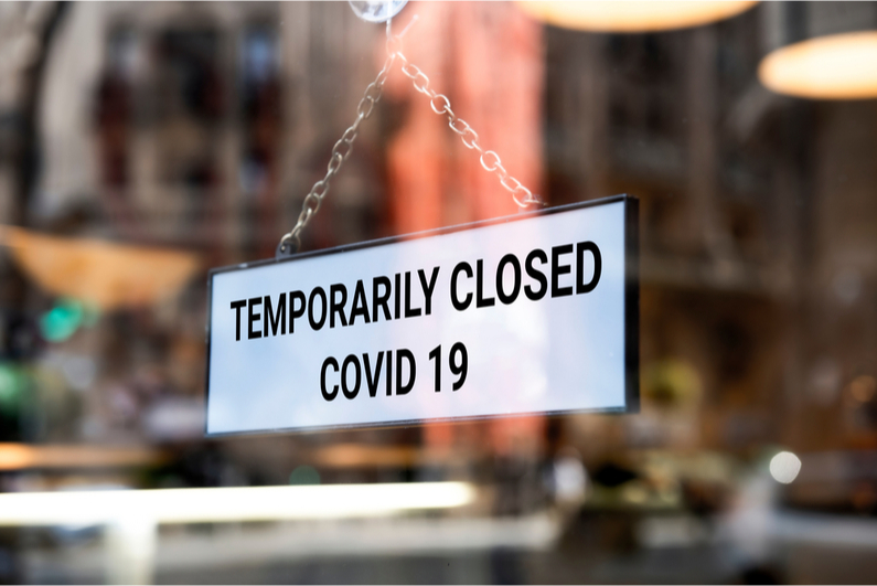 "Temporarily Closed COVID-19" storefront sign