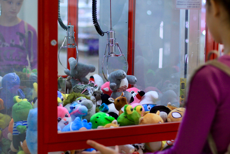 Girl playing a claw machine game