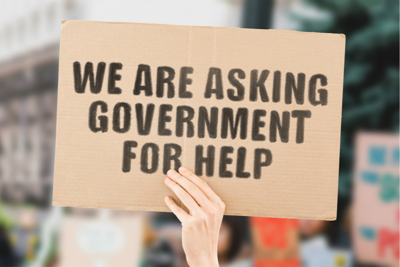 We Are Asking Government for Help cardboard sign