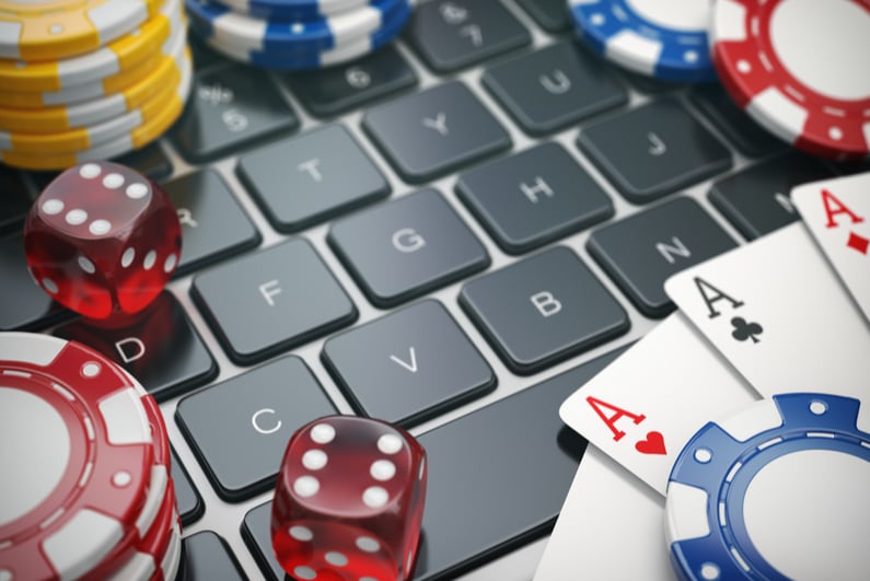 Chips, dice, and cards on a laptop keyboard