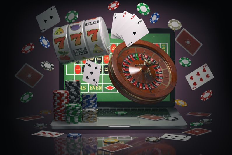 Roulette table on a laptop with gaming elements flying out of the screen