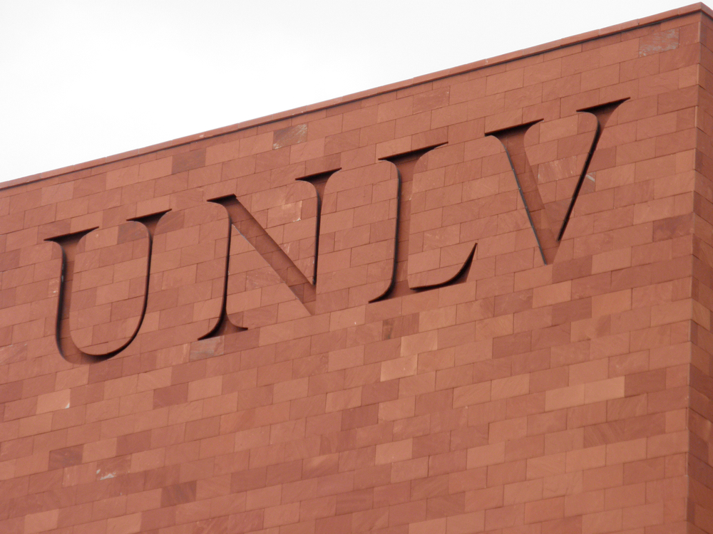 Letters UNLV inscribed on red brick building