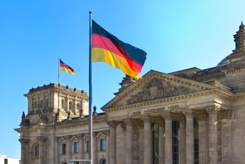 German flag flying outside of Parliament building