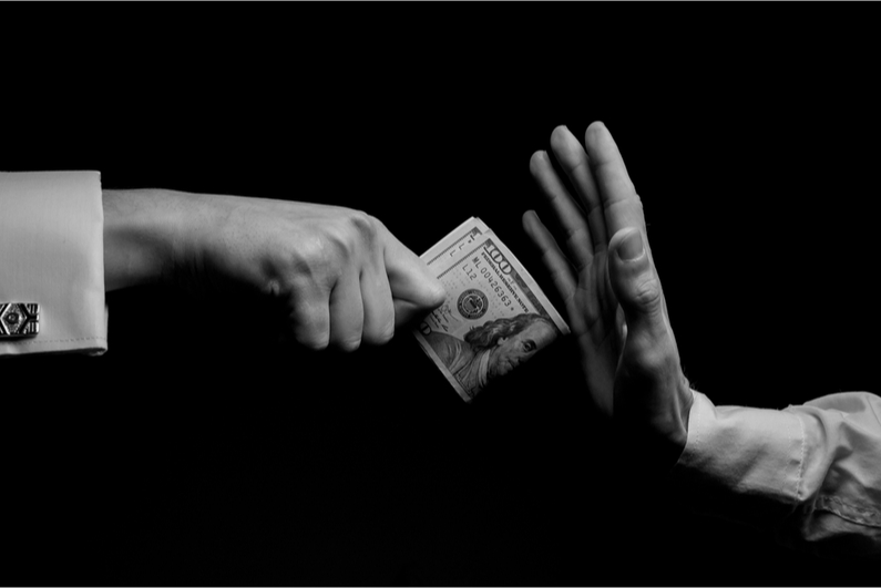 Closeup of person's hand rejecting money