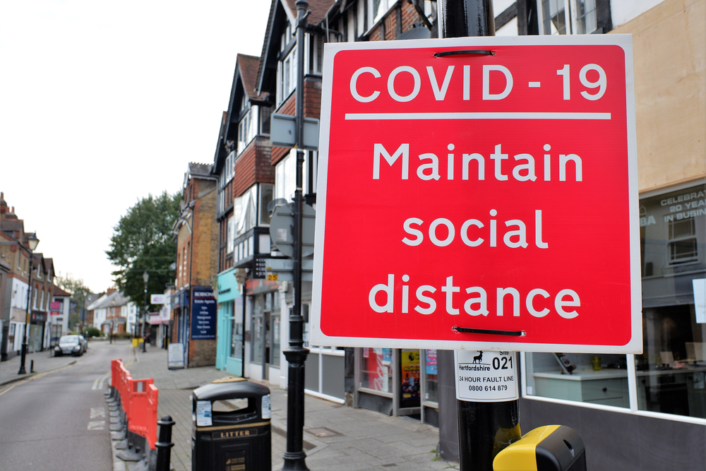 COVID-19 social distancing sign on street in England