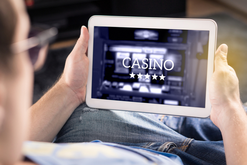 Man looking at casino gaming on a tablet