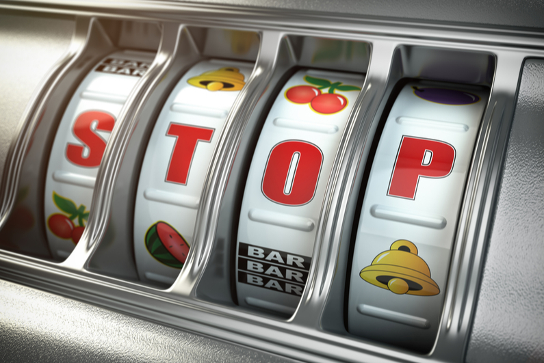 4-reel slot machine reading "STOP"