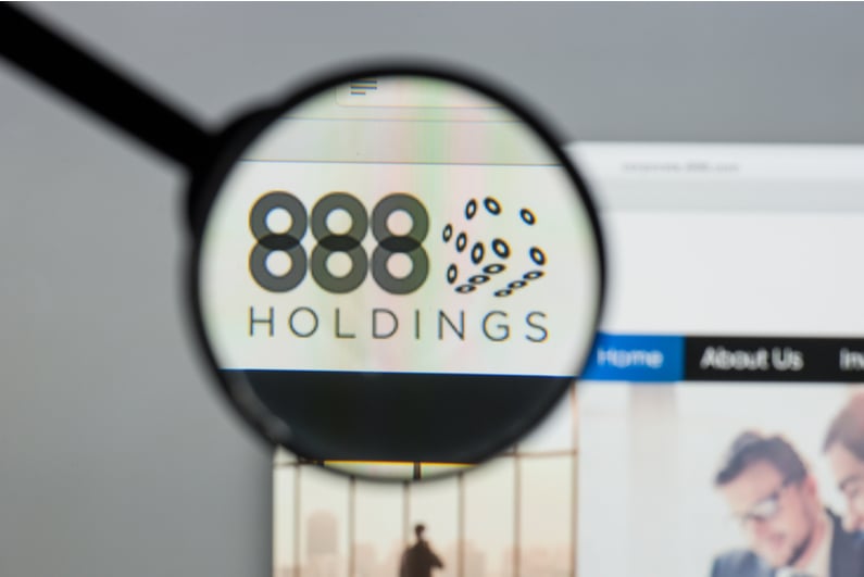 888 Holdings logo under a magnifying glass