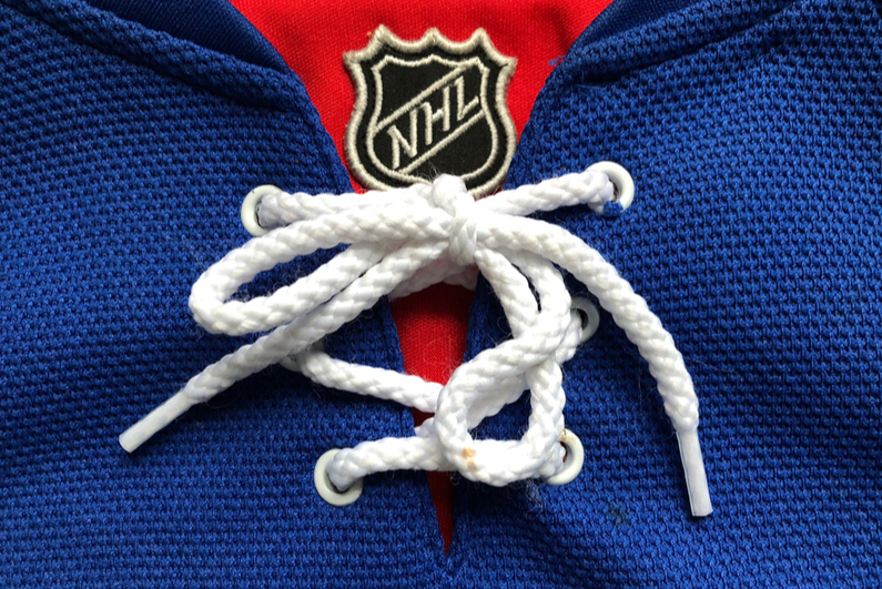 Closeup of a NY Rangers shirt featuring the NHL logo