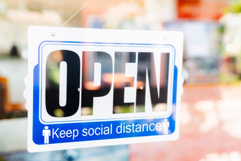 Window sign reading "OPEN Keep social distance"