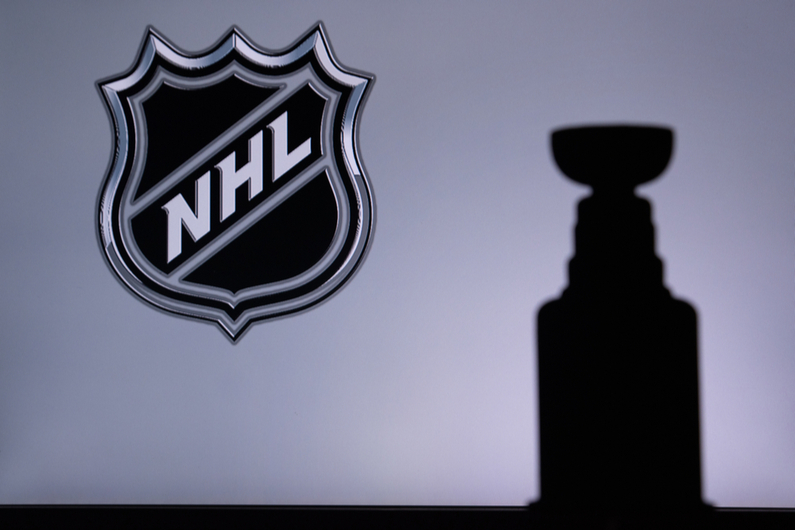 NHL logo with a shadow of the Stanley Cup in the background