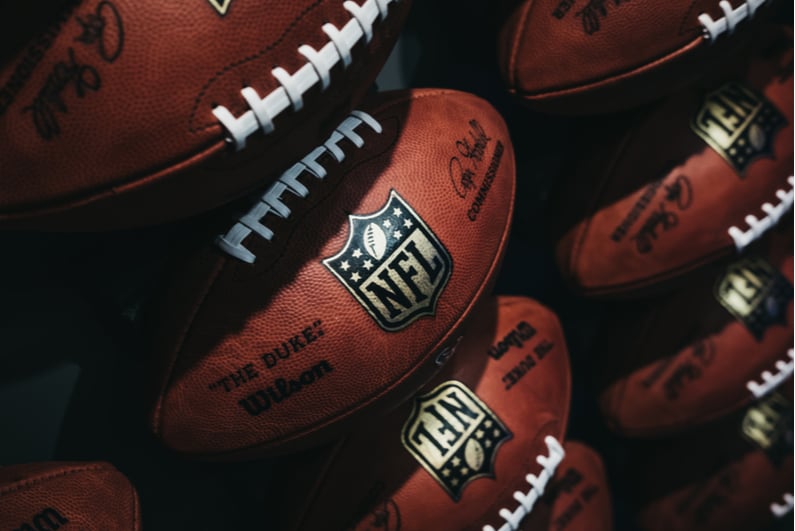 row of NFL footballs