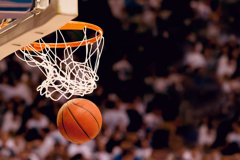 Basketball dropping through the net