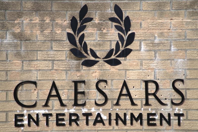 Caesars Entertainment logo on a brick building facade