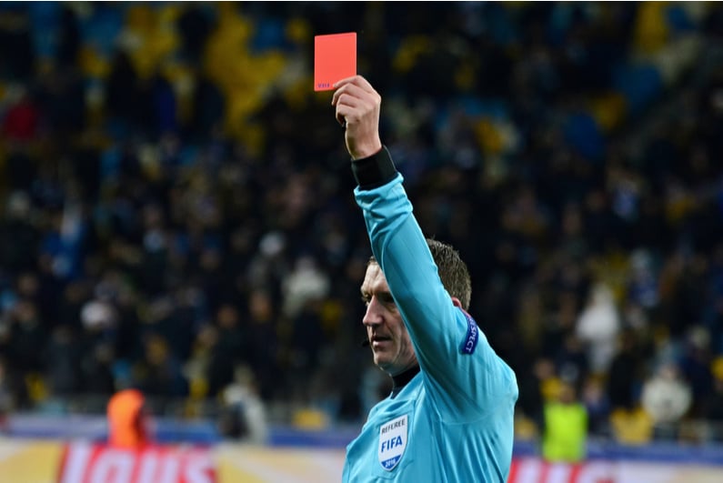 Soccer referee holding up a red card