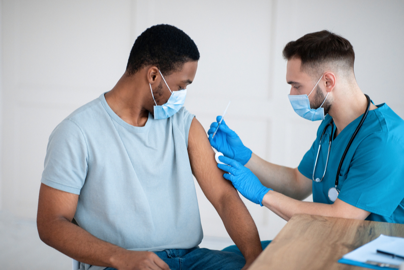 nurse administering COVID vaccine