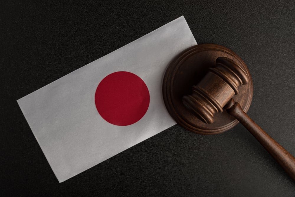 Japan flag under judge's gavel and block