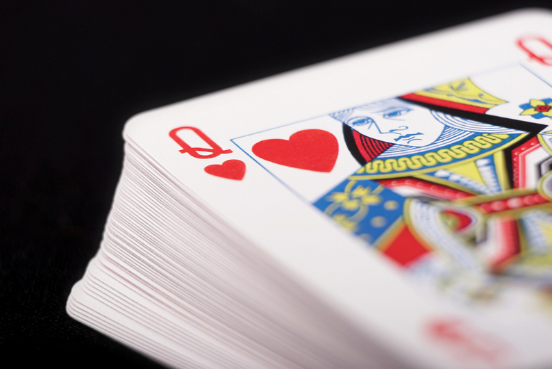 Deck of cards with the Queen of Hearts on top