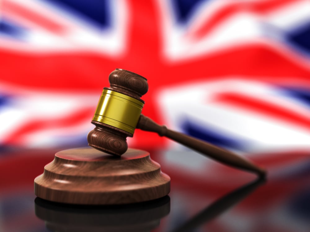 A wooden gavel with British flag