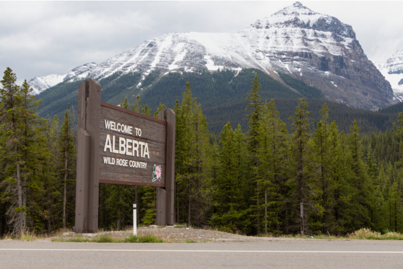 Alberta highway sign with the Rocky Mountains in the background