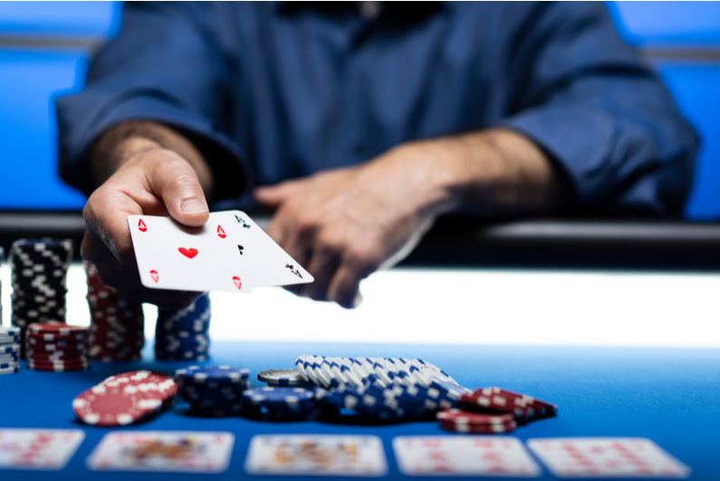 Player across the table revealing two Aces