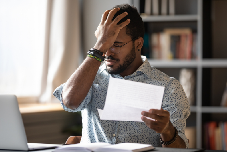 Man reading bad news in a letter