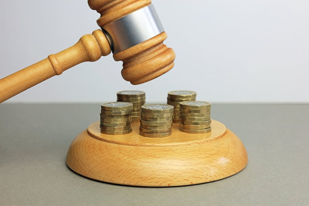 Wooden gavel with coins