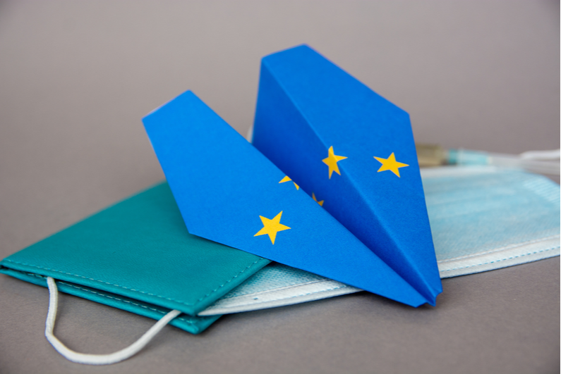 Paper plane with an EU flag design and a protective mask