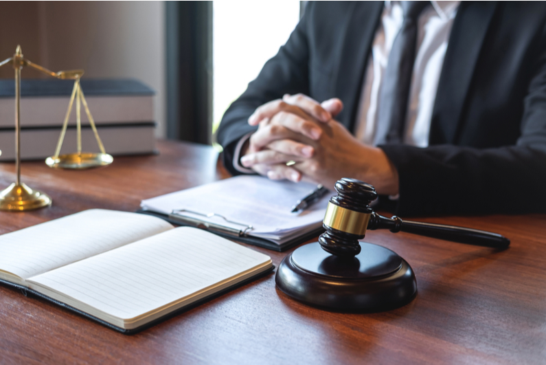 Lawyer at a desk with paperwork and a gavel