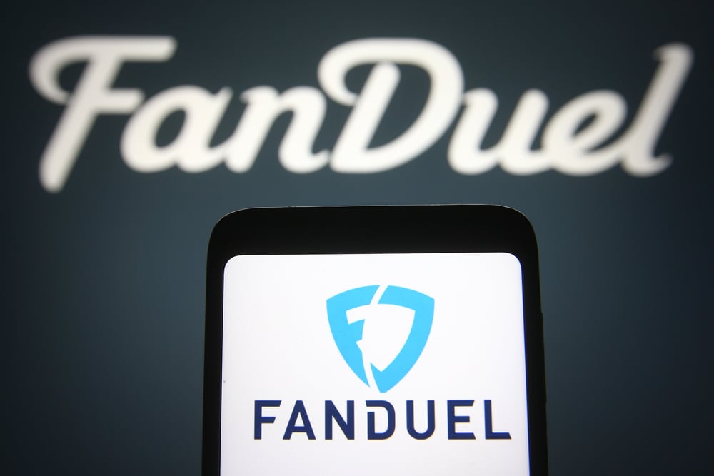 FanDuel logo on smartphone and on black background