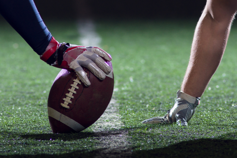 Football players ready to snap ball