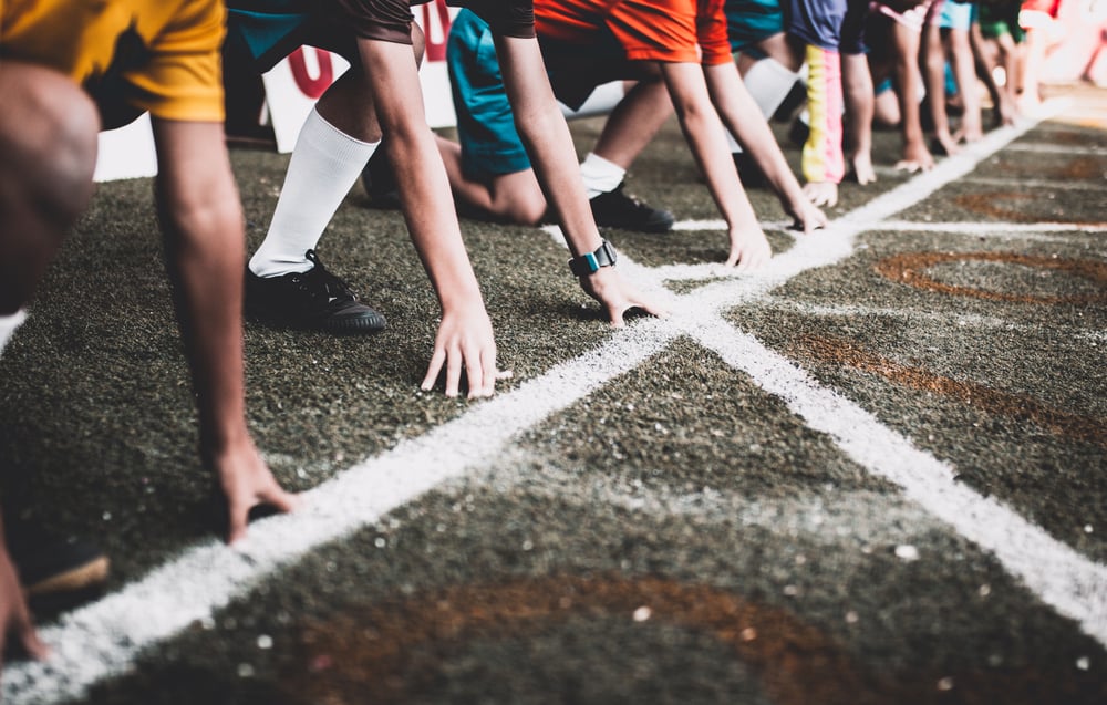 athletes lined up at the starting line of a race