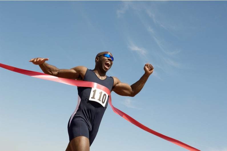 Runner breaking the tape at the finish line