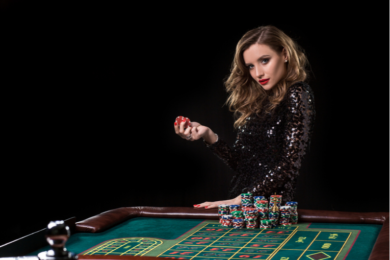 Woman holding chips at a roulette table