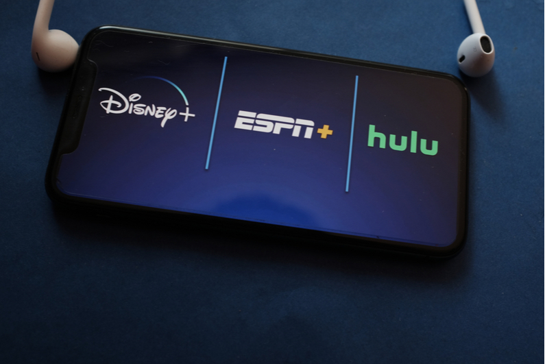 Disney+, ESPN+, and Hulu logos on a smartphone