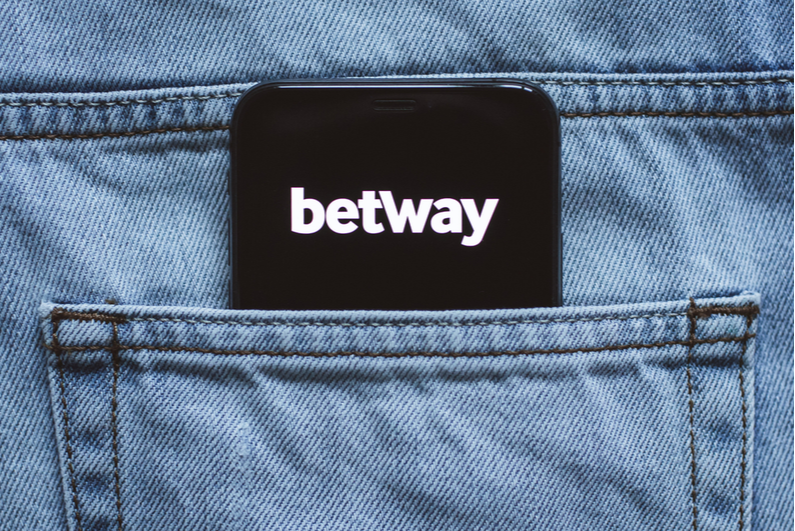 smartphone with betway logo in a person's back pocket