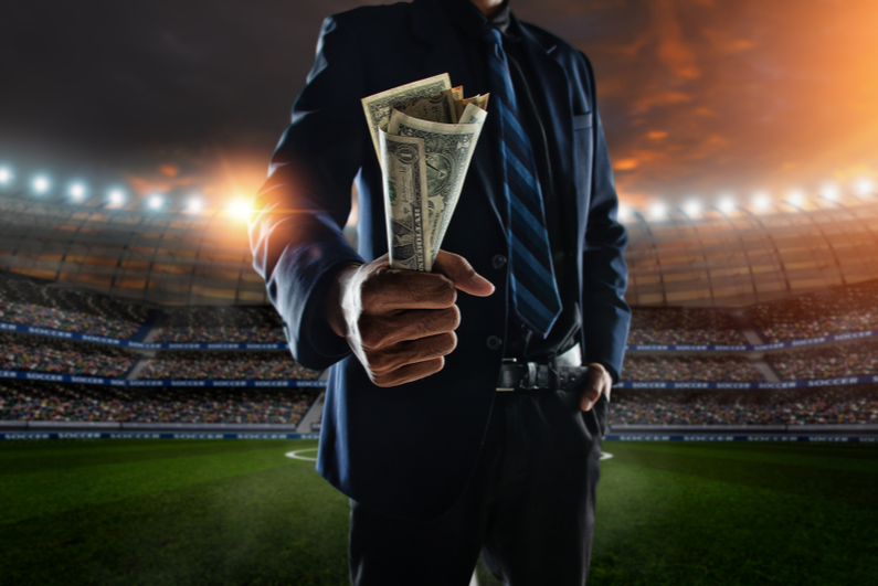 businessman holding a fistful of money