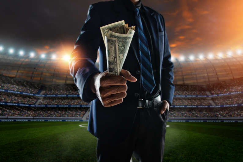 Businessman holding a fistful of money