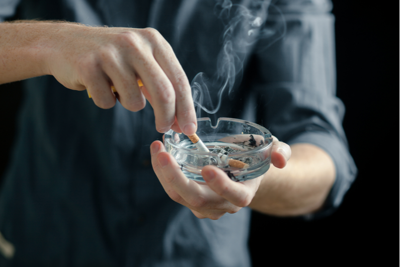 Man extinguishing a cigarette in an ashtray