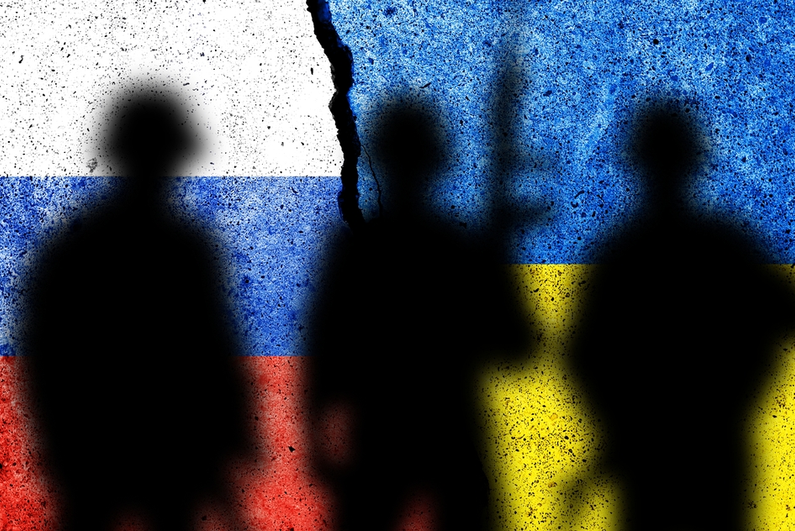 Ukraine and Russia flags with soldier shadows