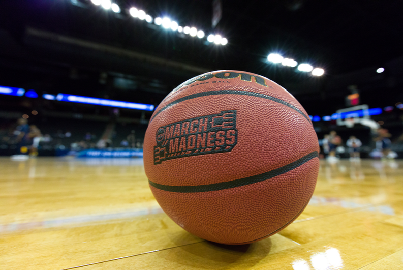 March Madness basketball sitting on the court