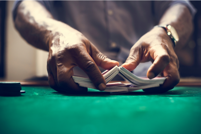 Closeup of man shuffling a deck of cards