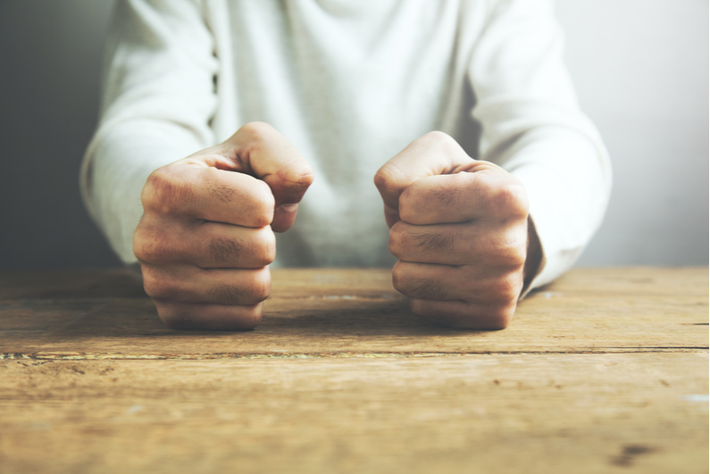 Fists on table