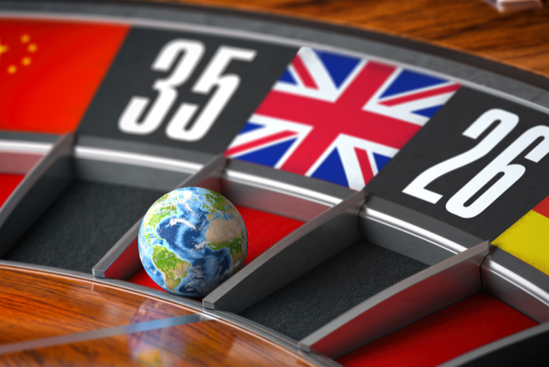 Roulette wheel with an Earth ball landing on a space containing a UK flag