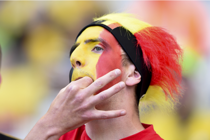 Belgian football fan whistles between his fingers